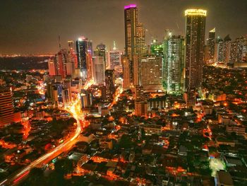 High angle view of illuminated city buildings at night