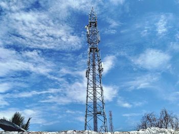 Low angle view of electricity pylon against sky