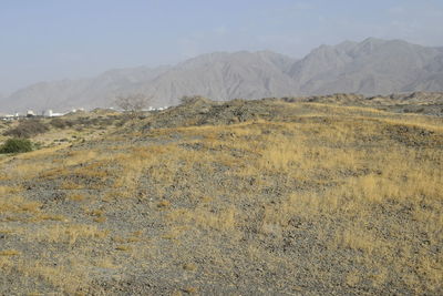 Scenic view of arid landscape against sky