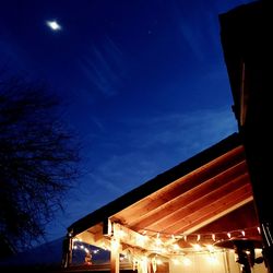 Low angle view of illuminated building against sky at night