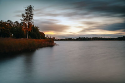 Scenic view of lake against sky during sunset