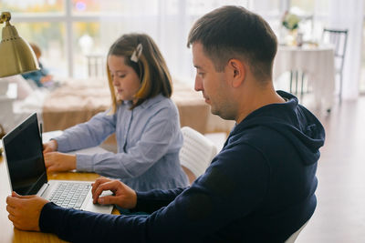 Young woman using laptop at office