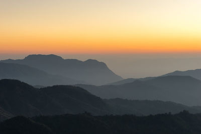 Scenic view of silhouette mountains against sky during sunset