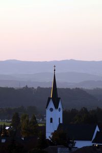 Traditional building against sky during sunset