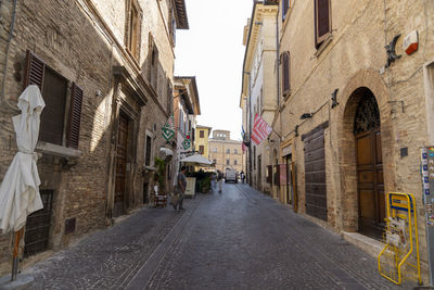 Narrow street amidst buildings in city