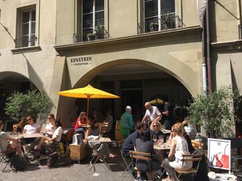 Group of people in restaurant against building