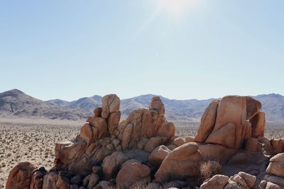 Rock formations on landscape against sky