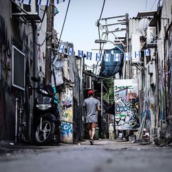Rear view of man on bicycle in city