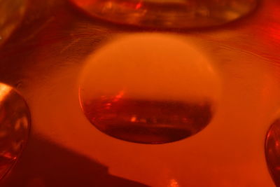 Close-up of wineglass against orange sunset sky