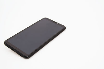Close-up of mobile phone over white background