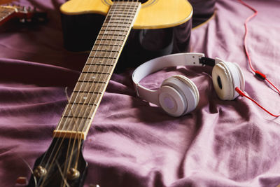 High angle view of guitar on bed