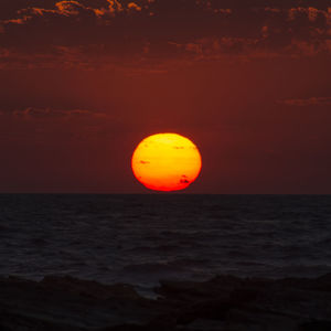 Scenic view of sea against romantic sky at sunset