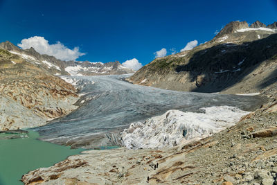 Scenic view of snowcapped mountains against blue sky