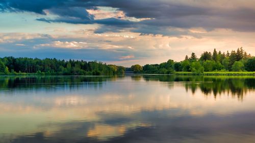 Scenic view of lake against sky at sunset