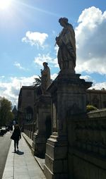 Statue of building against cloudy sky