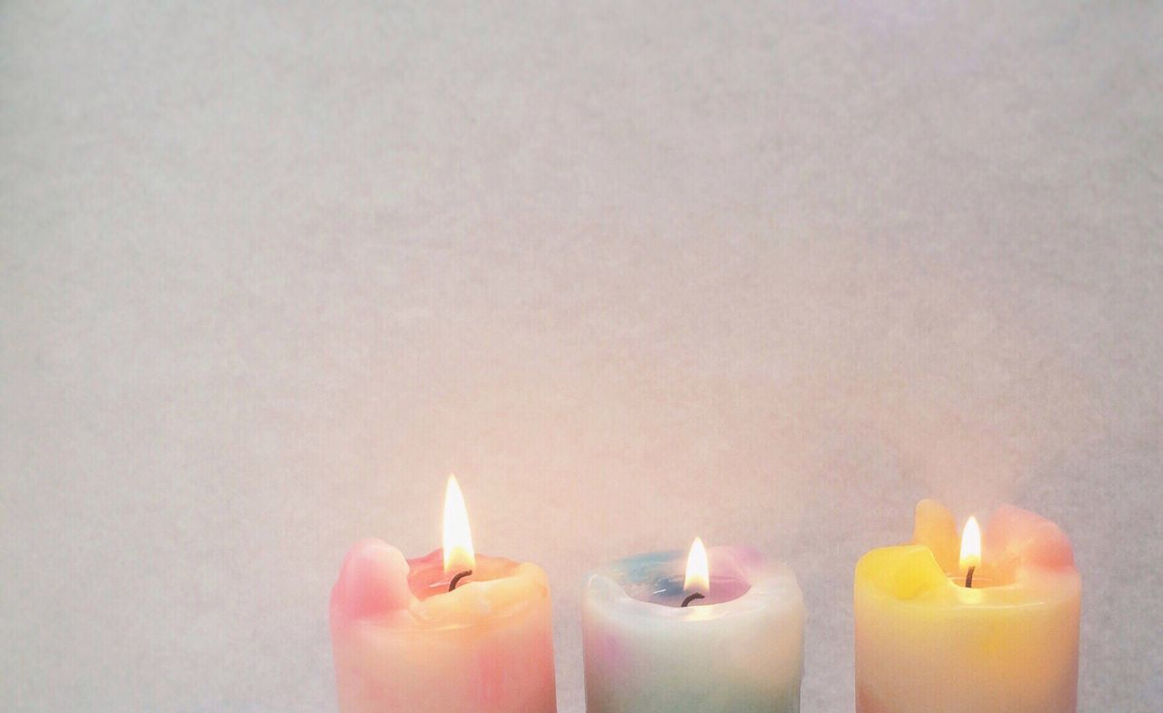 flame, burning, candle, indoors, heat - temperature, lit, fire - natural phenomenon, still life, glowing, close-up, illuminated, food and drink, candlelight, studio shot, copy space, glass - material, table, tea light, no people, bottle