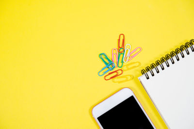 Close-up of multi colored pencils on yellow background