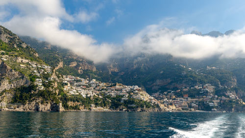 Scenic view of sea and mountains against sky