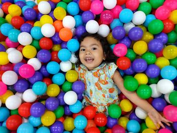 High angle portrait of cute girl with colorful balls