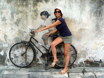 Full length of woman standing on wall