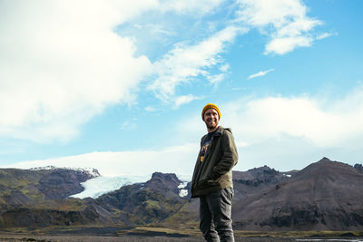 Full length of woman standing on snow covered mountain