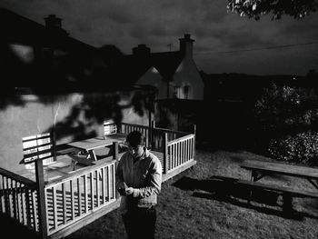 Man standing by built structure against sky