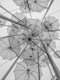 Low angle view of umbrellas sculpture against sky