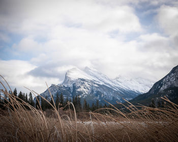 Snowy mountain mount rundle covered by snow and shrouded by clouds, banff national park, canada