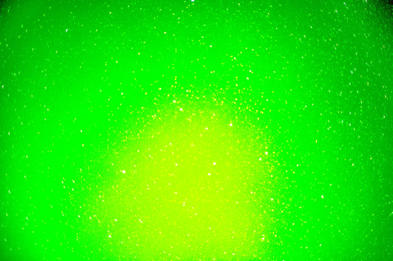 FULL FRAME SHOT OF MULTI COLORED WATER DROPS ON GREEN BACKGROUND