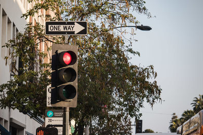 Low angle view of road sign against sky