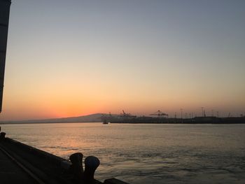 Scenic view of sea against clear sky during sunset