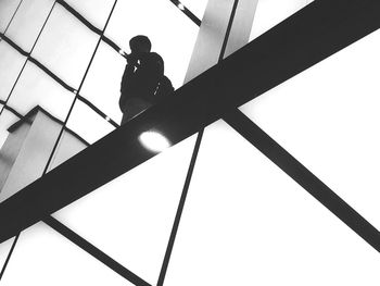 Low angle view of silhouette boy against clear sky