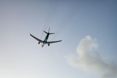 Low angle view of airplane flying in sky