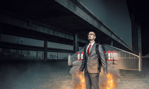 Man standing on bridge