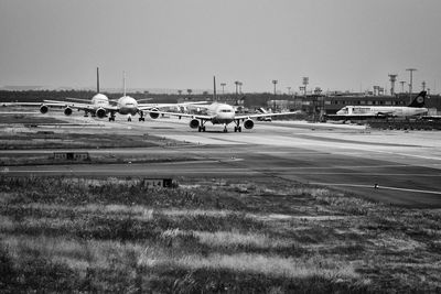 Airplane on runway against sky