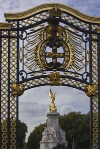 Low angle view of ornate statue against sky