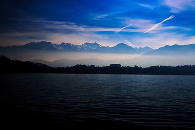 Scenic view of lake against sky at sunset