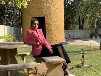 Portrait of woman sitting on tree