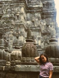 Full length of senior woman outside temple in building