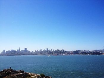 View of cityscape against clear blue sky