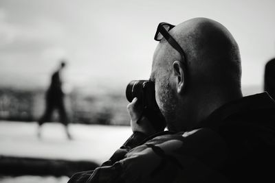 Man photographing through digital camera