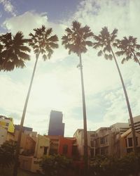 Low angle view of buildings against cloudy sky