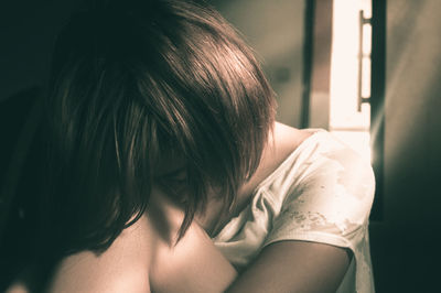 Young  woman looking down indoors