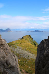 Scenic view of land and mountains against sky