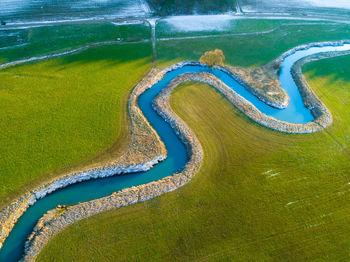 High angle view of river amidst field