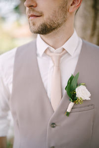 Midsection of man holding bouquet