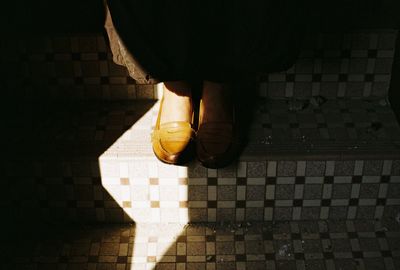 Low section of woman moving down steps