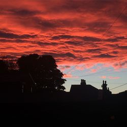 Silhouette of building against dramatic sky