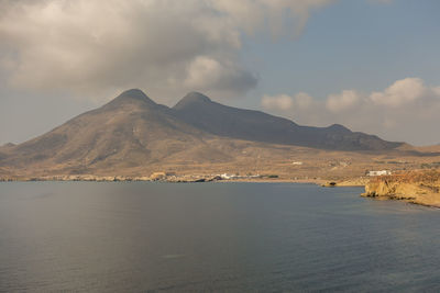 Scenic view of sea and mountains against sky