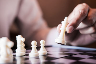 Midsection businessman playing chess